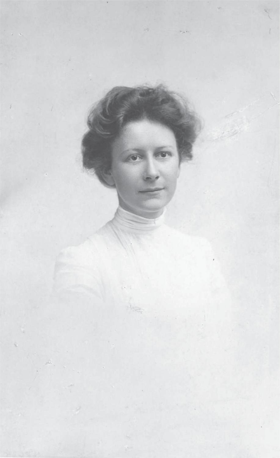 Black and white portrait of Annie in a high-necked white dress.
