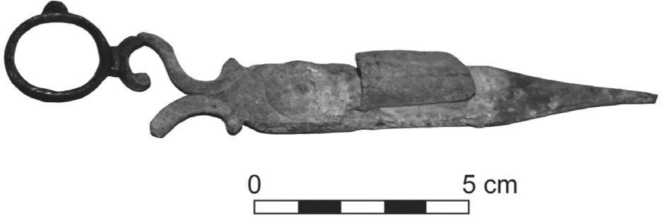 A black and white photograph of a candlesnuffer and wick trimmer. It has a round handle and is shaped like a knife sheath. 
