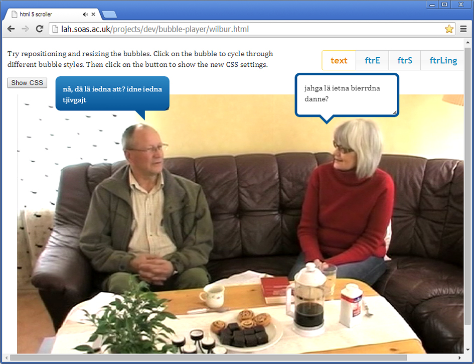 Figure 3.7. A screenshot from Edward Garrett's browser-based ELAN player. Two speakers sitting on a sofa in a living room converse while speech bubbles provide a transcript.