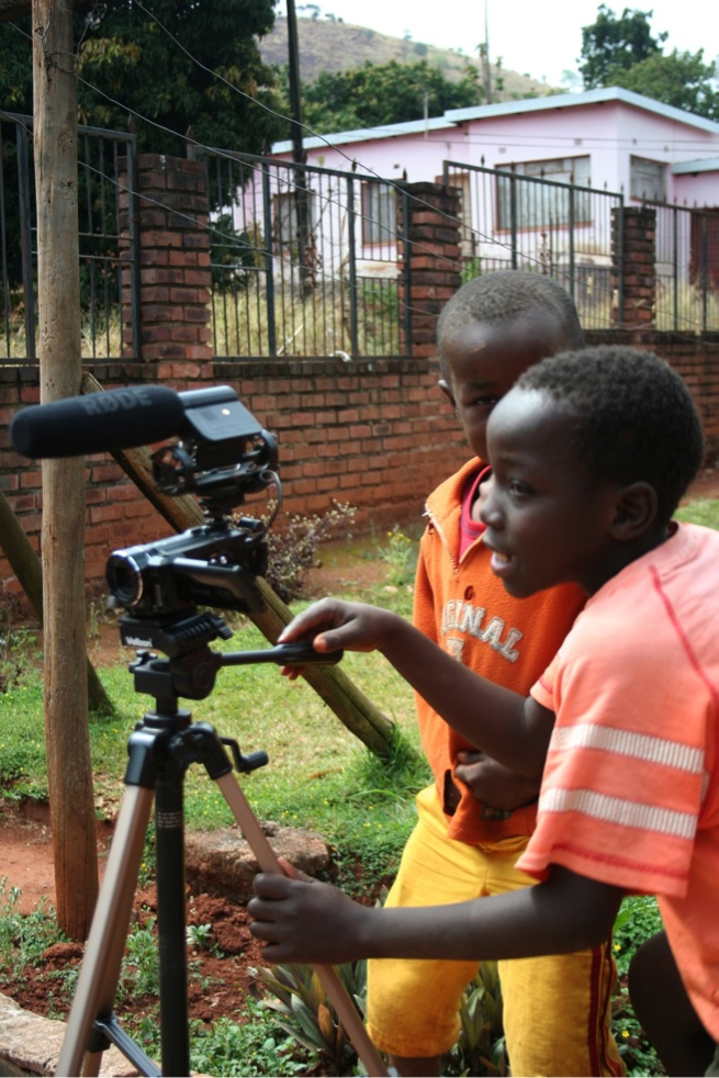 Figure 7.1. Two young boys of about 10 smile as they use a video camera.