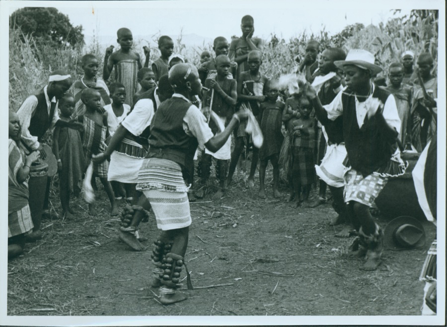 Figure 7.6. A black and white photograph shows several teenage girls dance animatedly while their peers watch on.