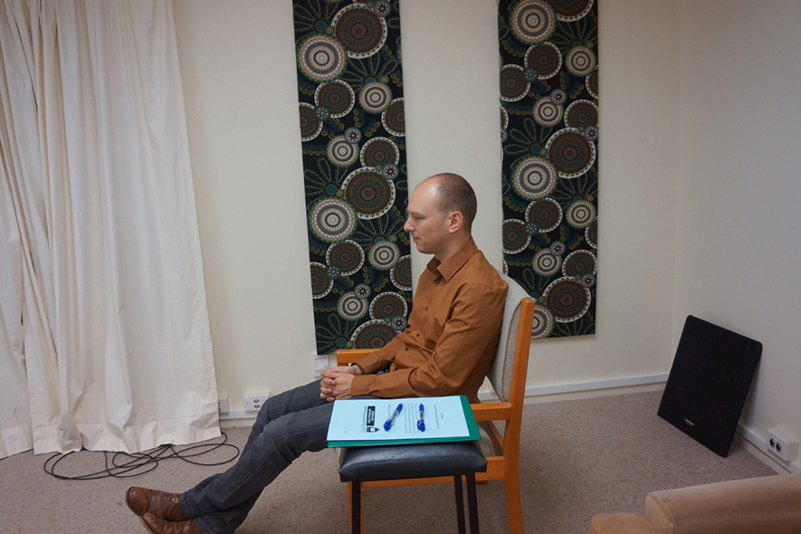 Man sitting in an Acoustic Research Centre listening room.