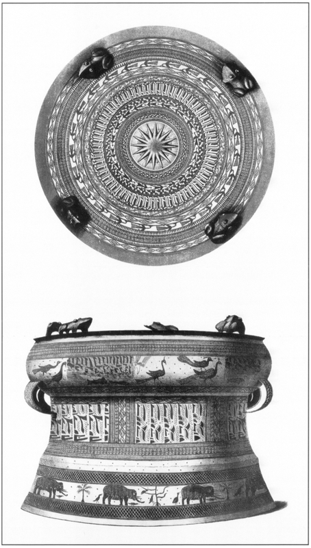A plate of the Salayar drum – with the top surface pictured on the top of the plate, and horizontal view from its side on the bottom. The top surface of a large drum made of bronze, waisted in the middle and closed at the top. It has four wooden carvings of frogs evenly spaced protruding around the edge of the drum-top. It is detailed with pictograms of various creatures like birds and tribal patterns around each circular ring. In the middle of the cover is a circle with a starry sun, star, or flower with numerous spikes. On the side portrait of the drum are several rings partitioned accordingly to the makeup of the drum. The top, thick end depicts tribal illustrations of peacocks and fish. Below that are geometrical tribal patterns, bordered by detailed lines and etchings. Separated by a space with small evenly sparse dots is the bottom which has a space illustrated with elephants, palm trees, and birds. The space is flanked by dense zig-zagged scales on top and bottom.