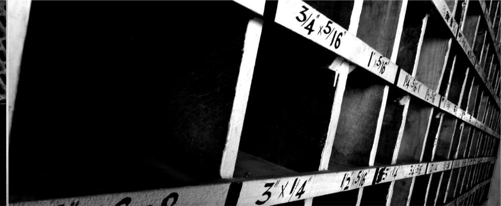 A black and white photograph of a wall with box shapes cut out and numbers marked on them.