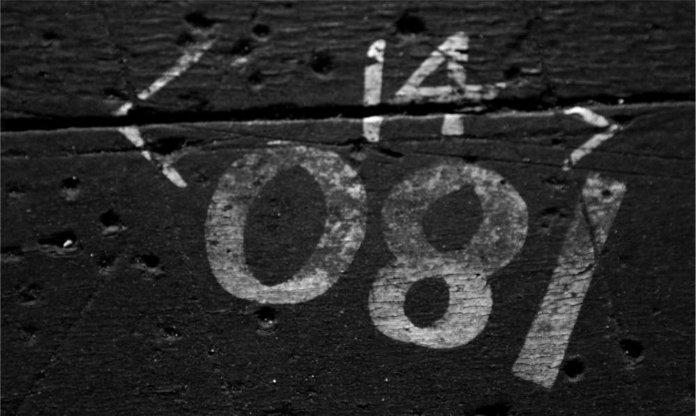 A black and white photograph of a surface with different numbers marked on it.