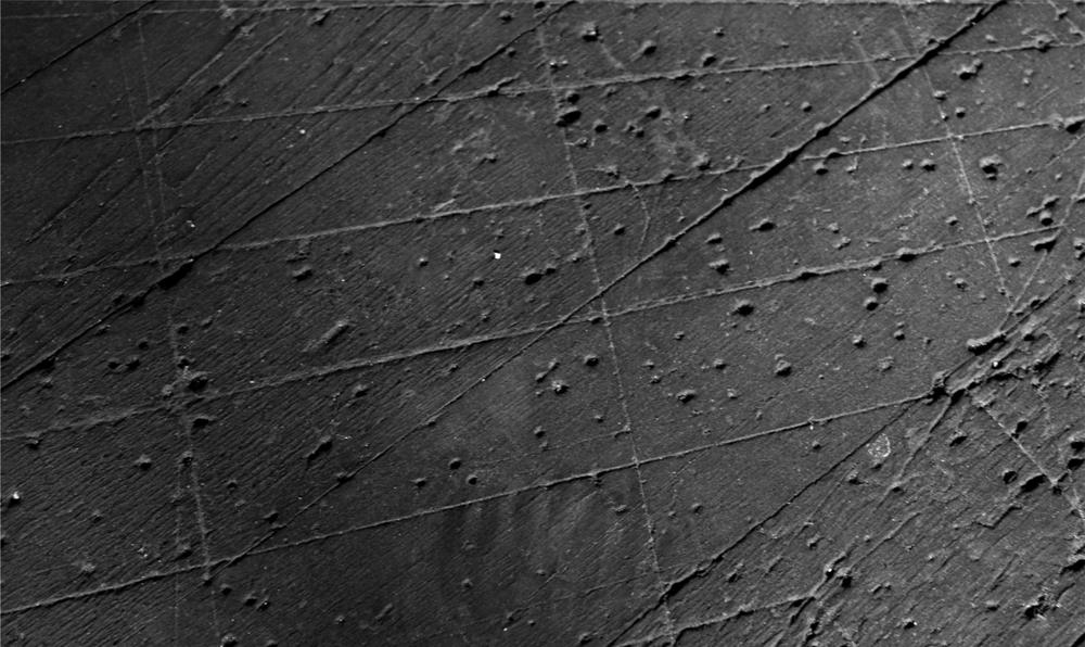 A black and white photograph of a pock marked surface.