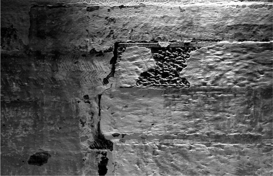 A black and white photograph of the wall of a building.