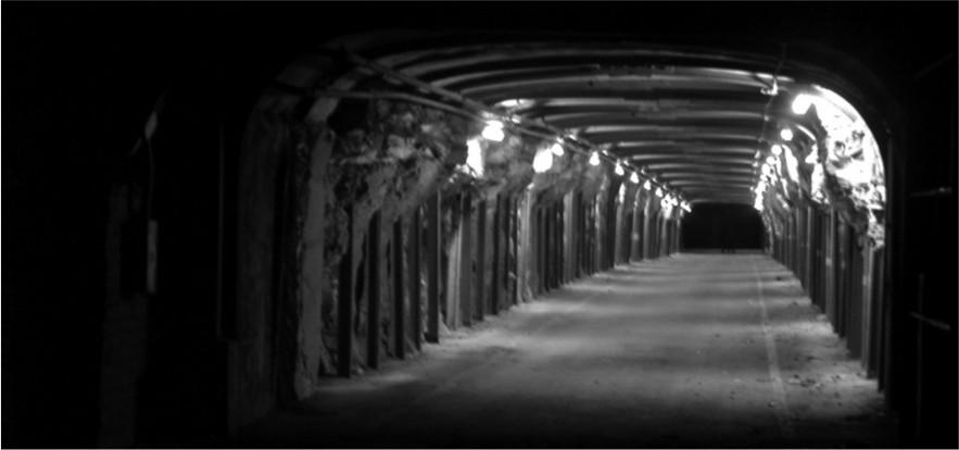 A black and white photograph of a passage way to the docks.