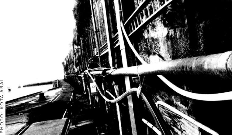 A black and white photograph of the edge of a building on the edge of Cockatoo Island.