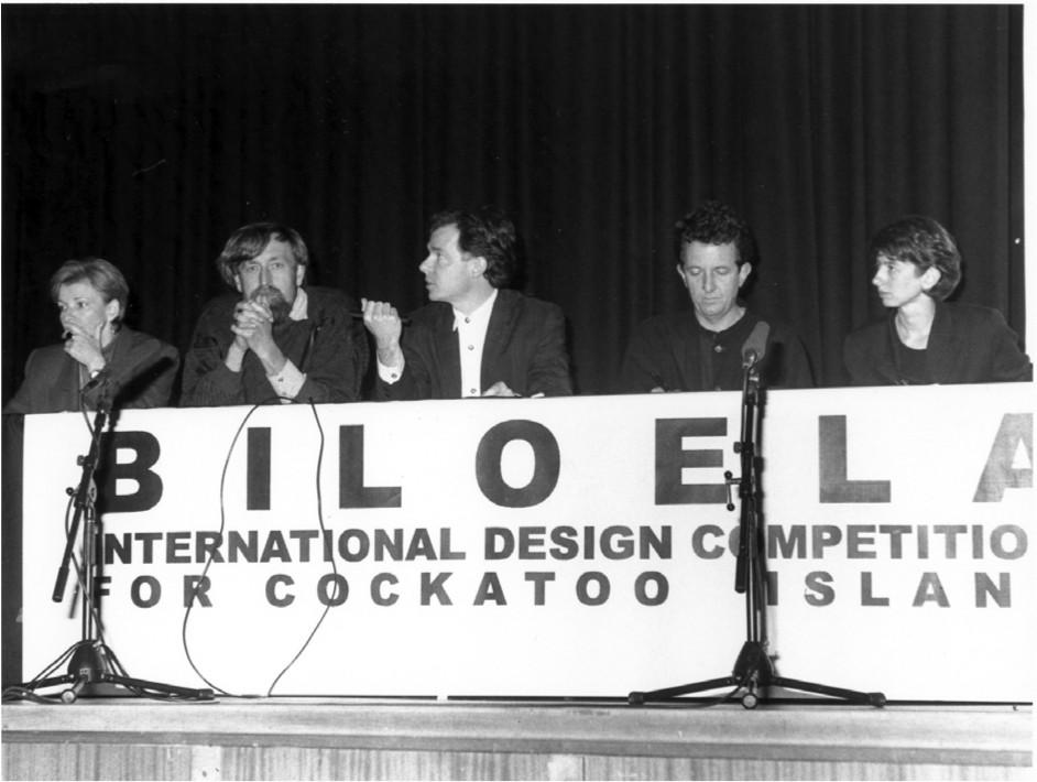 A black and white photograph of men and women on a panel at the Biloela design competition.