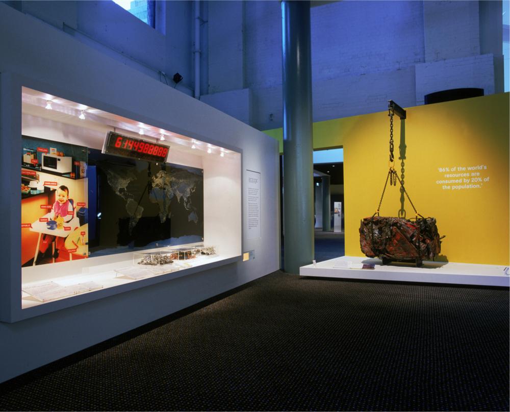 A photograph of a museum with a crushed car in the EcoLogic entrance.