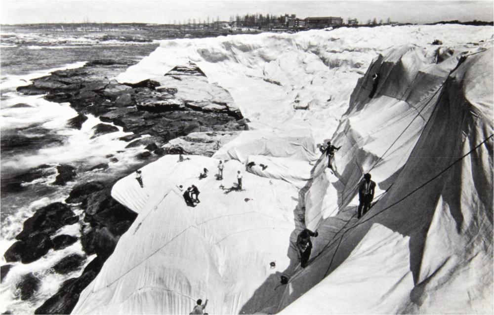 An artwork of people climbing on a snowy slope.