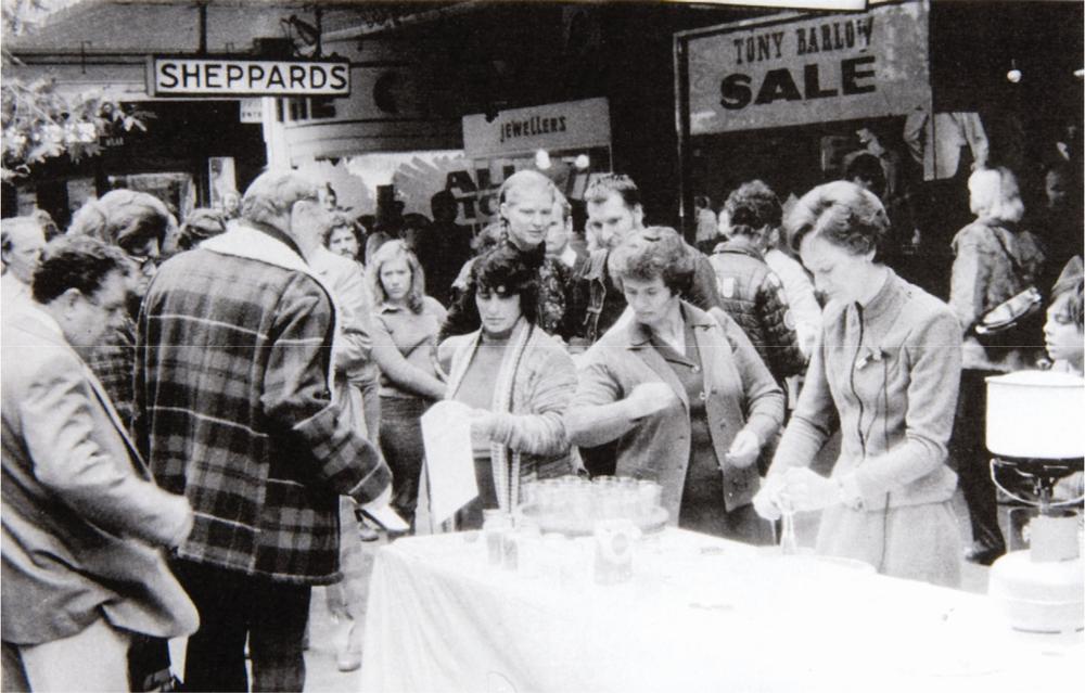 A black and white photograph of people at the Rundle Mall in Adelaide.