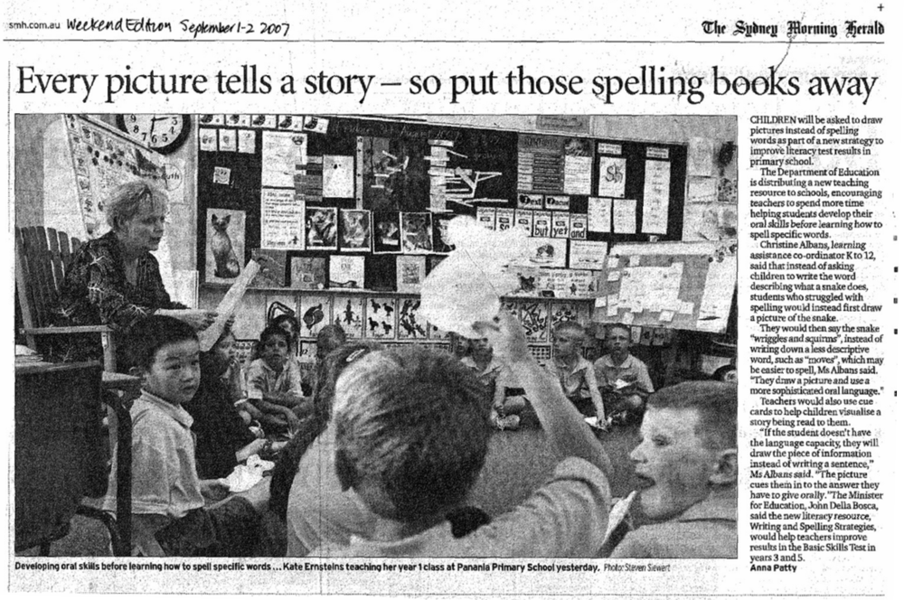 An image of a newspaper cut out titled 'Every picture tells a story - so put those spelling books away' There is an image of a classroom and a teacher sitting on a chair surrounded by her class.