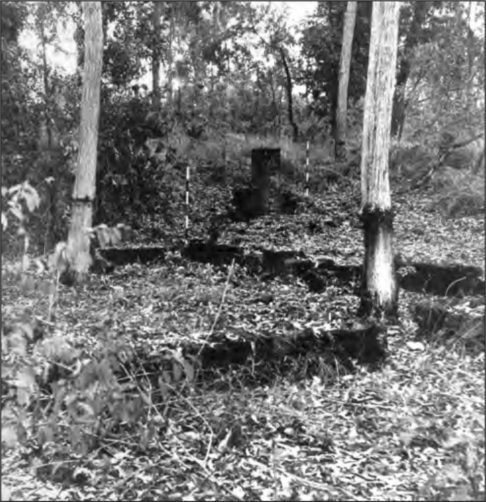 A black and white photograph of the hospital's foundations. The ground is lower, showing the outline of the foundations.