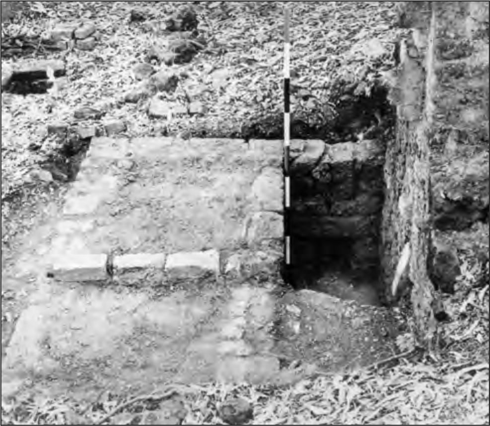 A black and white photograph of a rectangular hole with bricks surrounding it. 