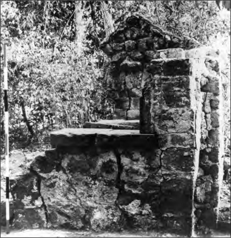 A black and white photograph of the bakery that has one wall torn down.