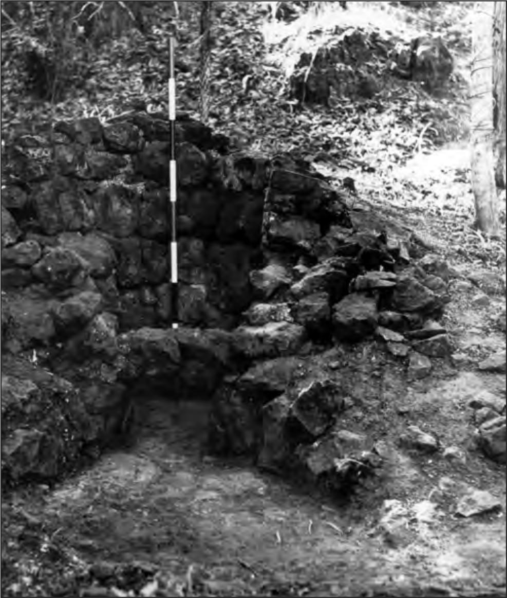 A black and white photograph of a kiln; it is circular but has mostly deteriorated.
