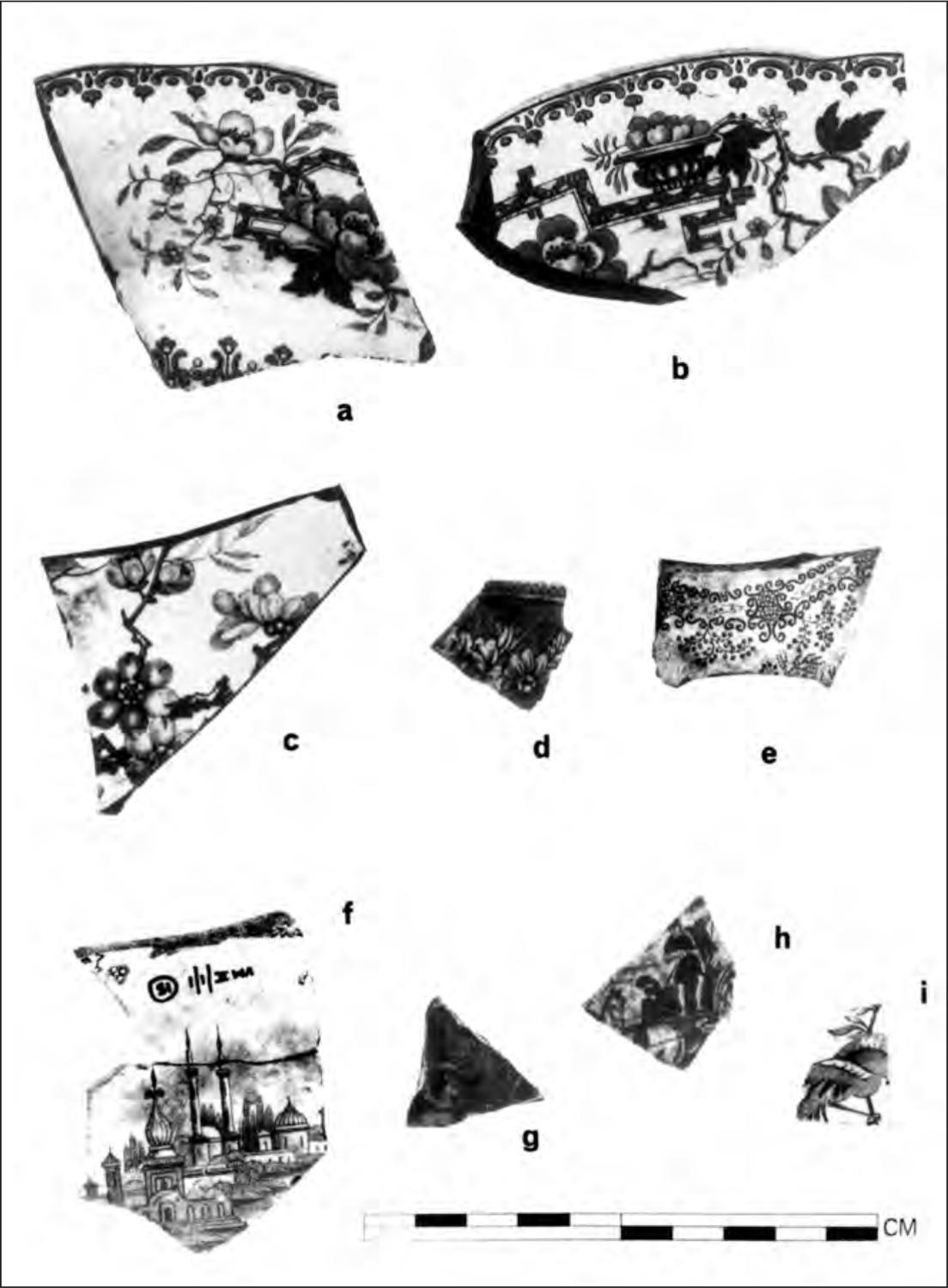 A black and white photograph of eight shards of pottery. All of them have detailed images, mostly of flowers blooming from branches. One has an image of a city.