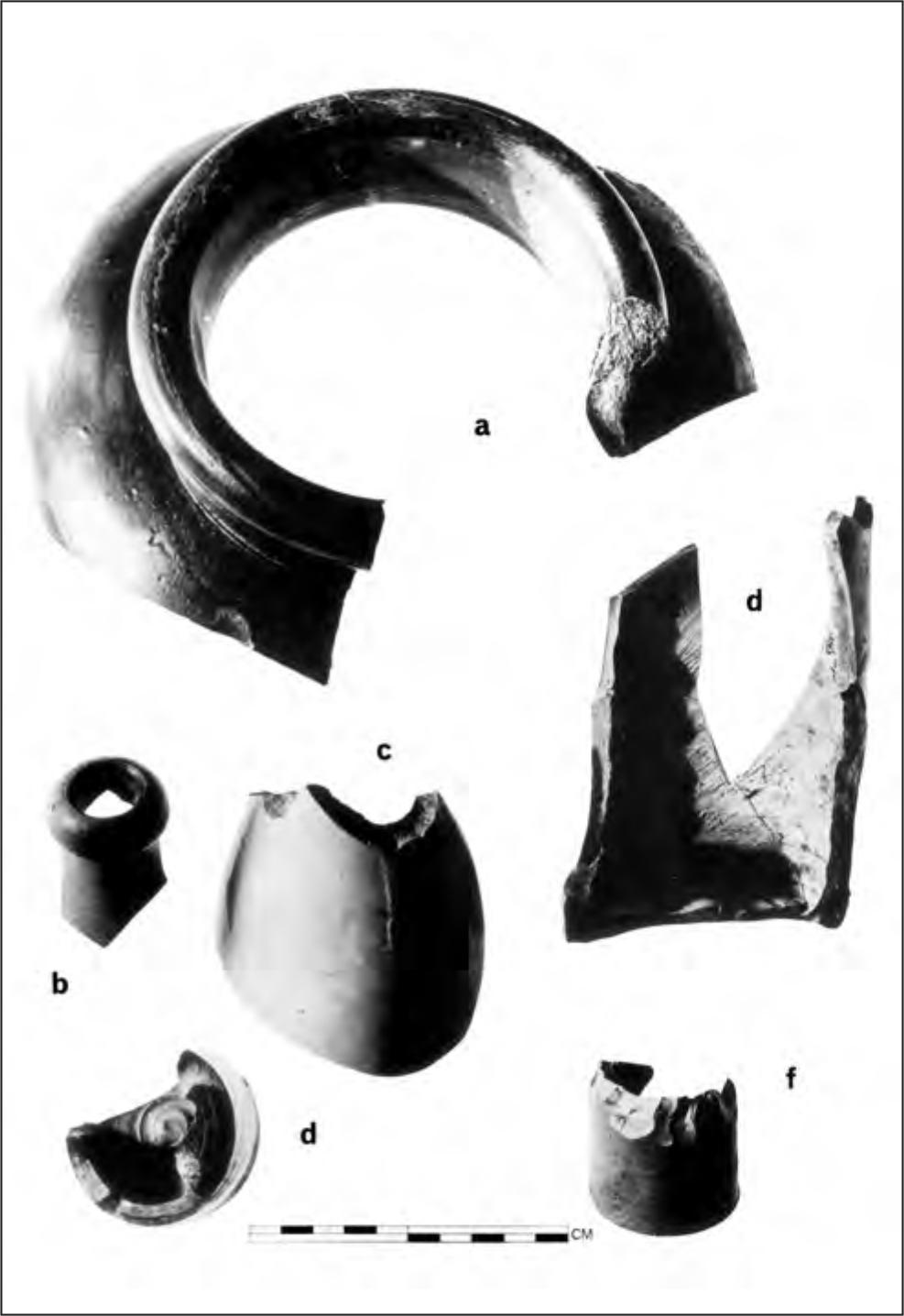 A black and white photograph of six pieces of stoneware. All of them have round shapes but are broken in places and seem as if they were each a part of a bottle.