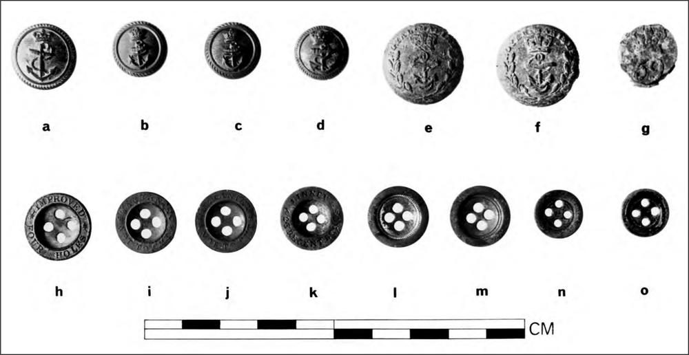 A black and white photograph of four brass naval buttons with a rope and anchor pattern, three Royal Marines pewter buttons with a rope and anchor surrounded by a wreath pattern, and eight buttons with four holes.