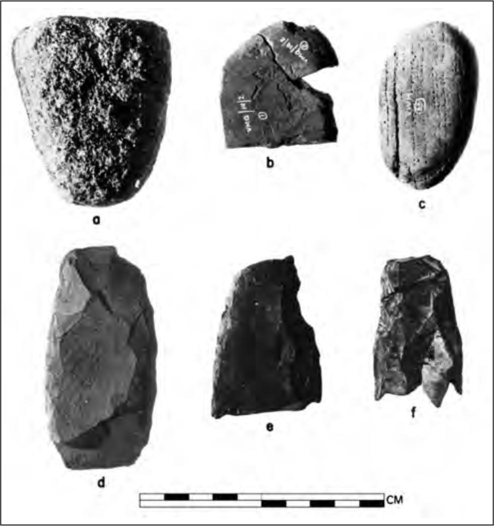 A black and white photograph of six artefacts that seem to be made of rock.