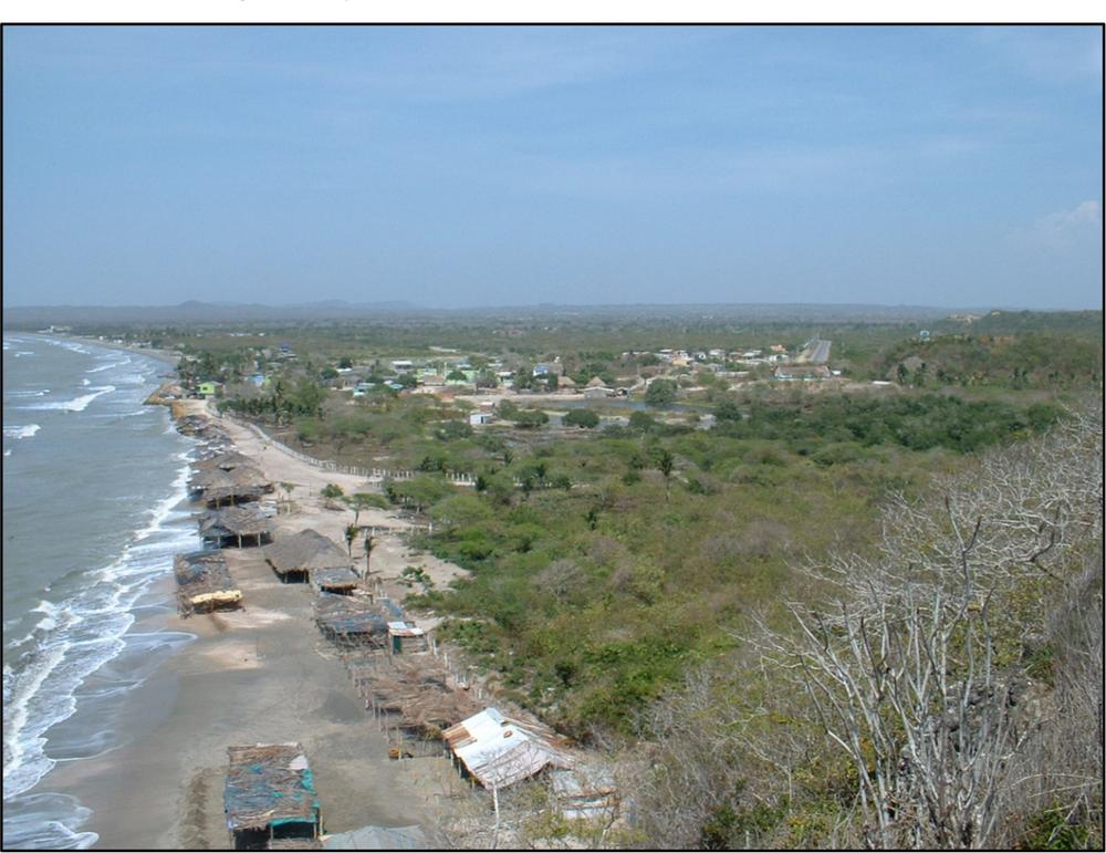 A photograph of view of Manzanillo del Mar with a beach front, water and a bush landscape..