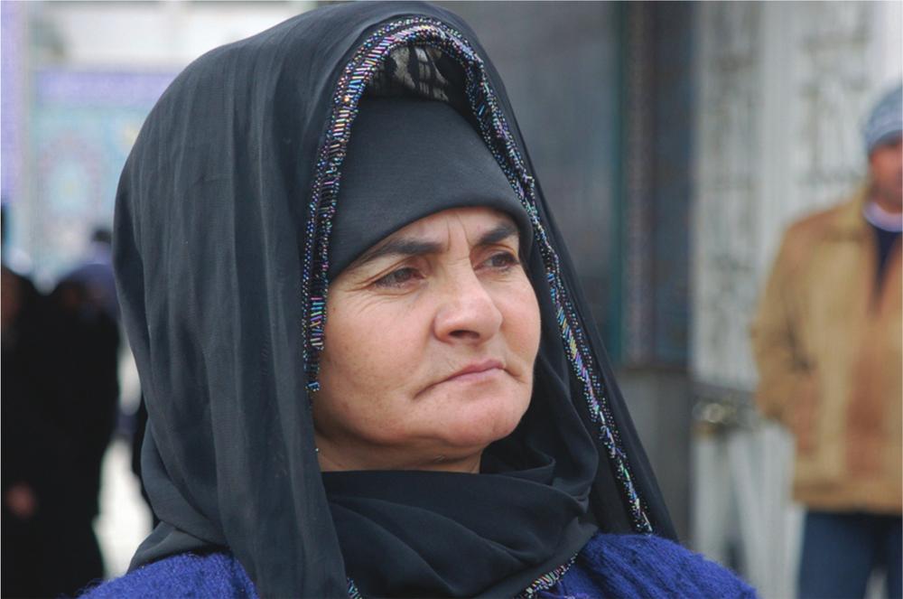 Close-up photograph of a woman looking into the distance.