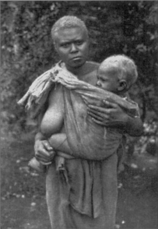 Black and white image of a mother and child posing for the camera.