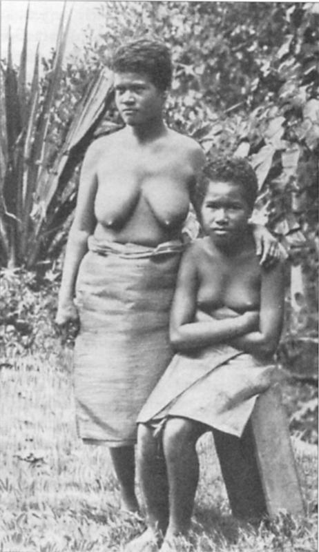 Black and white image of  two women in front of the trees.