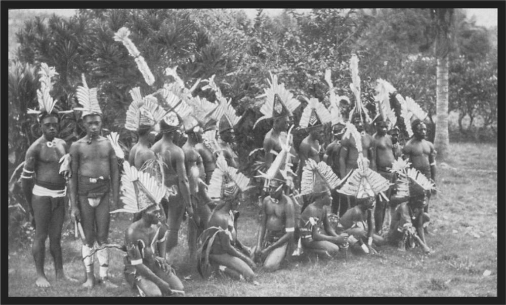 Black and white image of a group of dancers in their village.