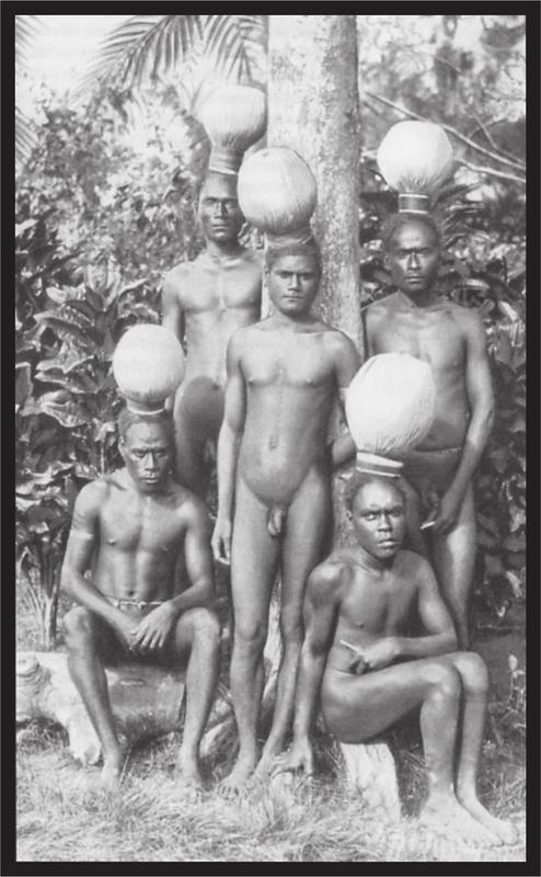 Black and white image of a group of men sitting in front of the trees.