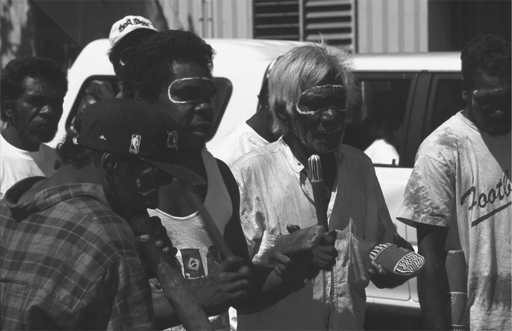 A black and white image of Charles Kungiung and Les Kundjil with a microphone singing.
