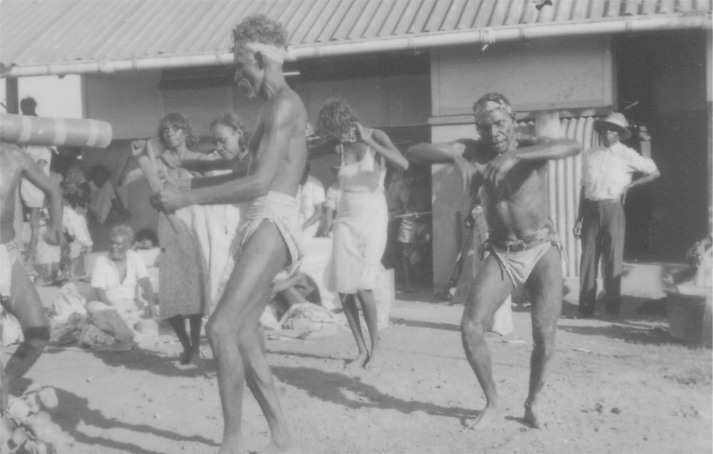 A black and white image of Jimmy Bandak singing at a ceremony.