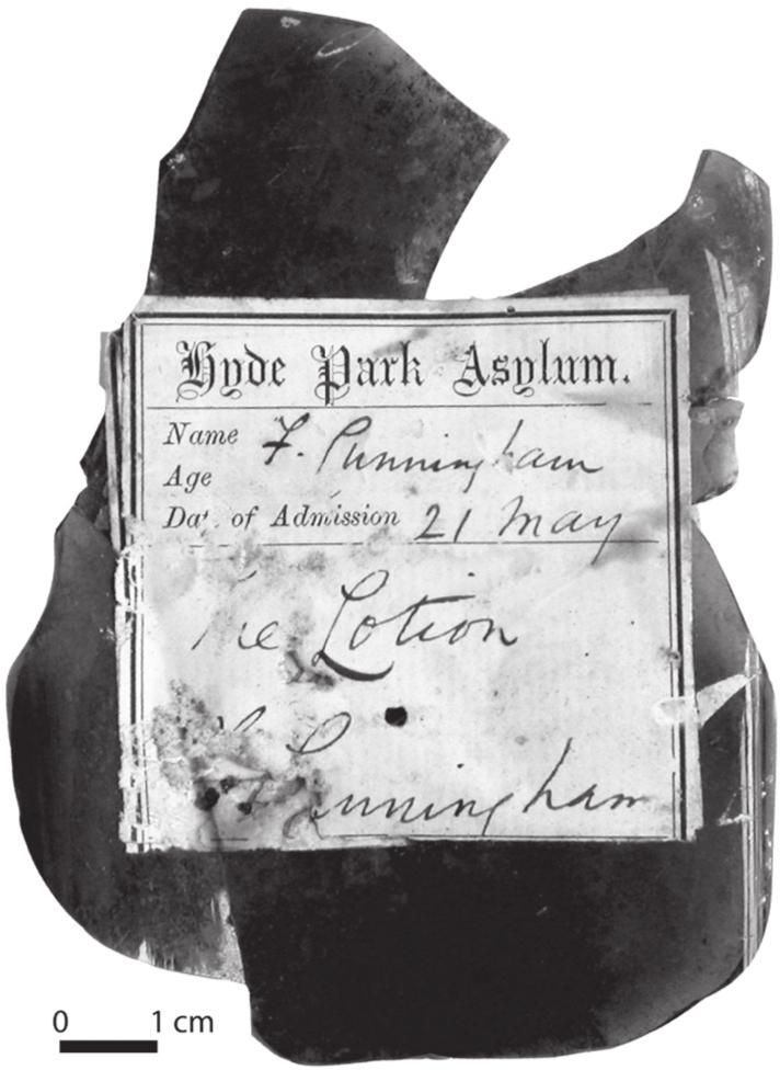 A black and white photograph of a Dispensary Label for ‘F Cunningham’ on a gin or schnapps bottle.