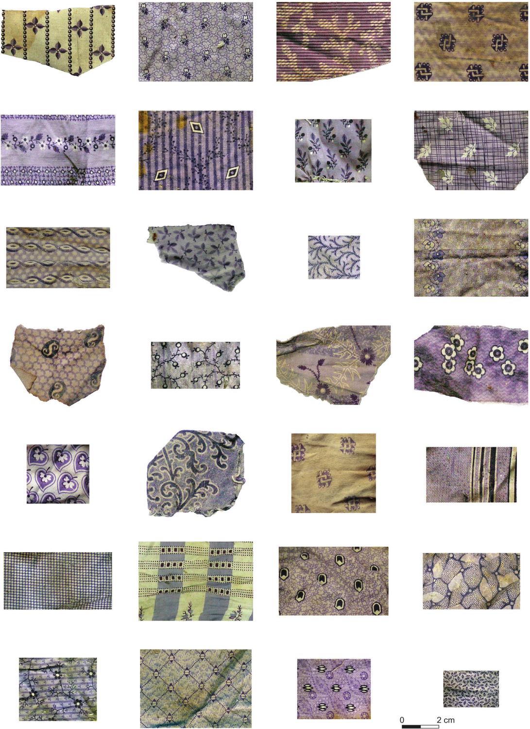 A photograph of a collection of small pieces of purple prints. Many have floral designs and pale yellow colours.