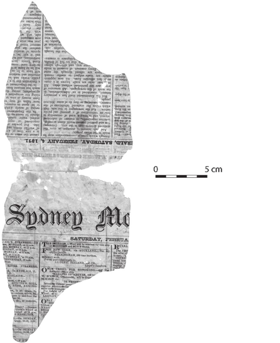 A black and white photograph of a torn newspaper. The word 'Sydney' can be seen.