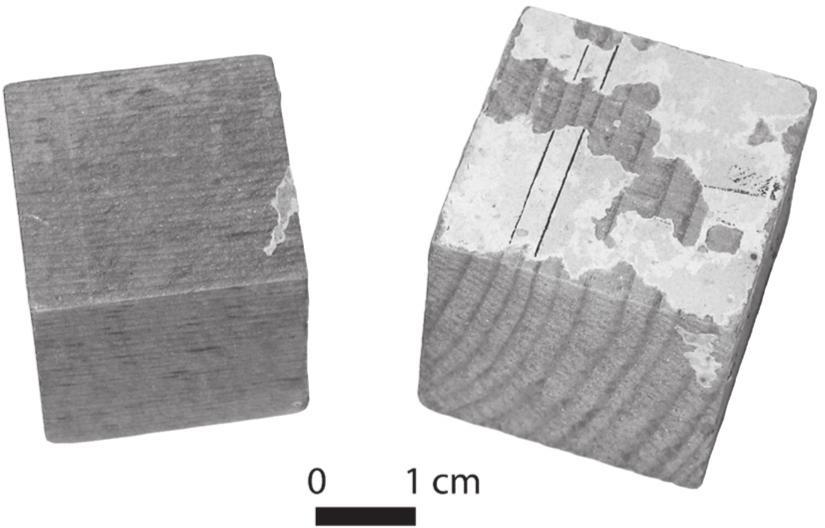 A black and white photograph of two wooden blocks.