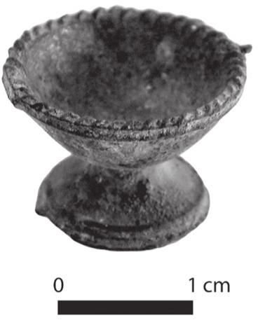 A black and white photograph of a small pedestal fruit bowl.