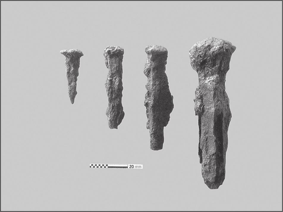 A black and white photograph of four shafts that resemble the shape of a nail.