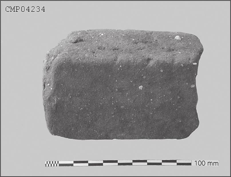 A black and white photograph of mud brick.