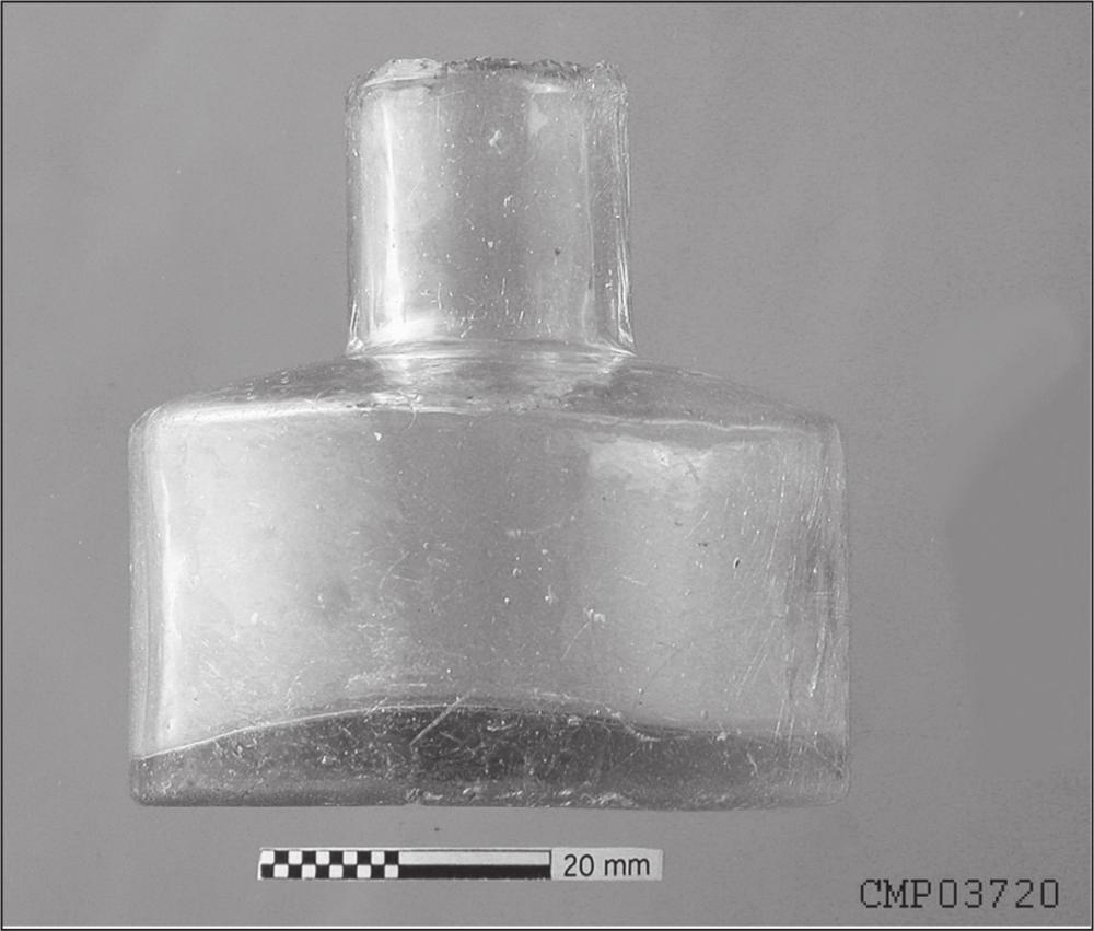 A black and white photograph of a cylindrical, short bodied, shear top inkwell