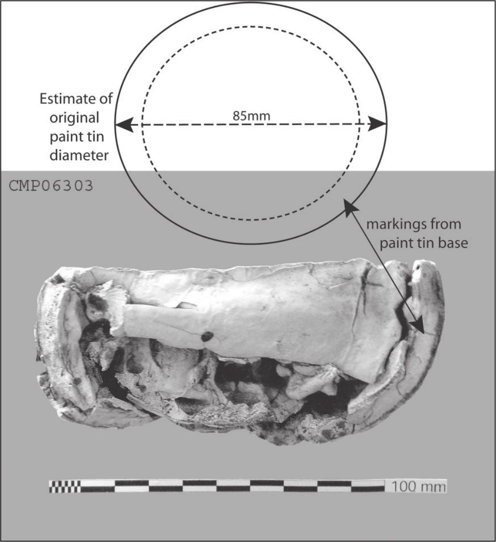 A black and white photograph of a bundle of dry paint with markings of the tin base. A drawing of the paint tin is illustrated with an 85mm diameter.