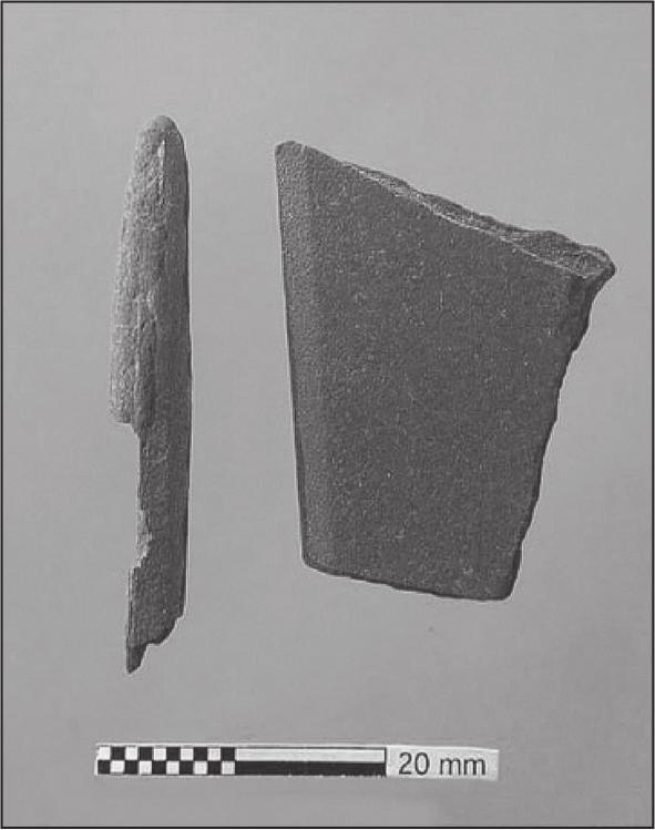 A black and white photograph of a broken slate pencil with a writing board.